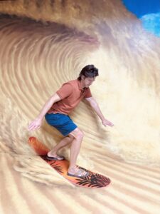 Sand surfing in the 3D Selfie Museum in Dubai